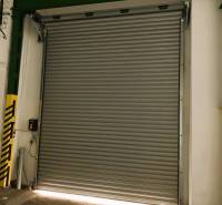 Industrial rolling door for warehouses and halls, closed, with green and yellow protective strip.