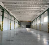 Spacious interior of a warehouse and hall with a reinforced concrete ceiling and smooth concrete floor.