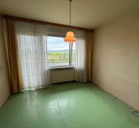 A room with a green floor and a large window in a 3-room apartment.