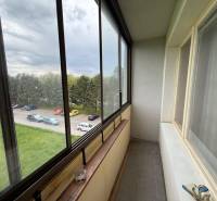 Glazed balcony with a view of the parking lot and greenery in Detva, 3-room apartment.