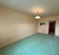A room in a 3-room apartment with neutral walls and light floor decor.