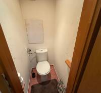 A toilet with a WC bowl and accessories in a 3-room apartment.