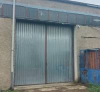 The gate of the warehouse in Košice, Juh district, with a metal surface.