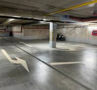 Underground garage with parking spaces, markings, and a motorcycle, Košice - Staré Mesto district.