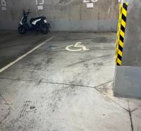 Handicapped parking space with a parked scooter in the garage.