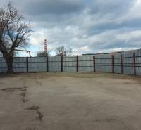 A fenced plot with a concrete surface in Košice, Juh district, suitable for commercial use.