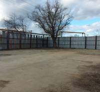 Commercial land in Košice - Juh district with fencing and trees.