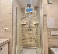 Shower enclosure in a 4-room apartment with tiles and a modern shower head.