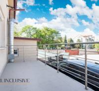A balcony of a building in Dunajská Streda with a metal railing and a view of the surroundings.