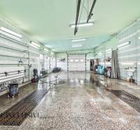 Interior wash hall with a wet floor and light tubes on the ceiling.