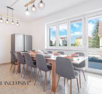Dining room in a building with a large table and a view of Dunajská Streda.