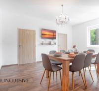 Dining room with a set table, chandelier, and wooden decor flooring in a building.