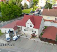 Villa Otto building in Dunajská Streda with a red roof and a parking lot.