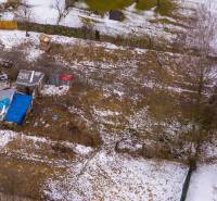Gardens in Nálepkovo covered with a thin layer of snow with visible makeshift shelters.