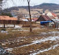 Winter scenery in the village environment of Gardens in Nálepkovo with scattered snow and buildings.