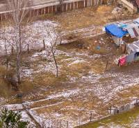 Gardens in Nálepkovo covered with snow with fencing and wooden structures.