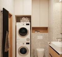 A bathroom in a 4-room apartment with a washing machine, dryer, and modern sink.