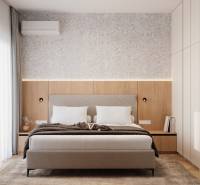A bedroom with a gray headboard, wood-patterned flooring, and soft lighting in a 4-room apartment.