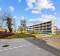Apartment building on Skalická Road in Bratislava - Nové Mesto. In the foreground are parking spaces.