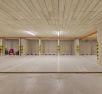 Underground parking spaces with marked pillars in color coding.
