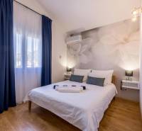 Bedroom in a villa with large flowers on the wall and a floor with a wooden decor.