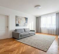 Living room in a two-room apartment with a comfortable sofa and a wooden decor floor.