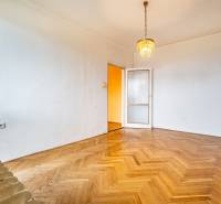 An empty room with a chandelier, doors, and a wooden-patterned floor, 2-room apartment.