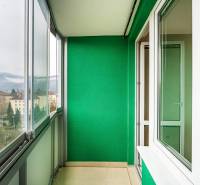 A green balcony with a view of buildings and mountains in Banská Bystrica on Trieda SNP.
