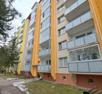 Multi-storey apartment building on Za dráhou Street in Ružomberok with glazed balconies.