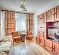 Living room with a wooden set, sofa, and television in a family house.