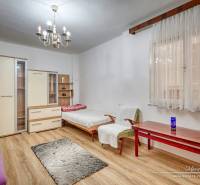 A family house with wooden flooring, chandeliers, and furniture, a room with daylight.