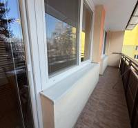 Balcony space in a 3-room apartment with windows and tiles.