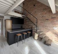 Kitchen corner with a bar and staircase in a 4-room apartment, floor with wood decor.
