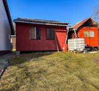 Red buildings near the vineyards on Ambrova Street in Nitra with a plastic water tank.