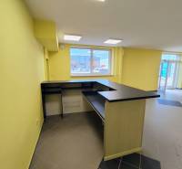 Bright commercial space with a counter and tiled floor.