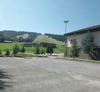 Ski slope in Makov with an adjacent building and greenery in the surroundings.