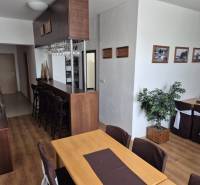 The interior of the restaurant with wooden furniture, pleasant lighting, and decorative plants.