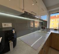 A kitchen unit with an electric stove and a window in a 2-room apartment.