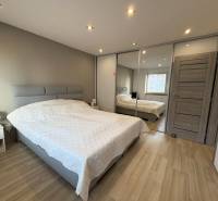 Bedroom in a 2-room apartment with a wooden decor floor.