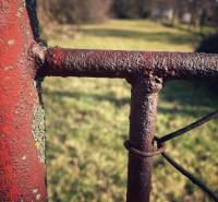 Rusty wire mesh and a post in the garden of a family house in Horné Chlebany.