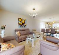 Living room in a family house with leather sofas and a glass table.