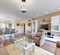 Living room of a family house with leather seating and a wooden decor floor.