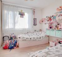 Children's room in a 3-room apartment with toys and a bed, floor with wooden decor.