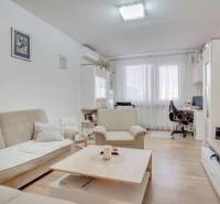 Living room with a sofa and TV in a 3-room apartment, floor with wooden decor.