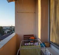 A balcony with a view of the city, a clothes drying rack, typical for a 3-room apartment in Nové Zámky.
