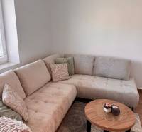 Comfortable light sofa and table with decoration in a 2-room apartment.