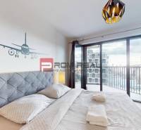 Bedroom in a 2-room apartment with a balcony and airplane decor on the wall.