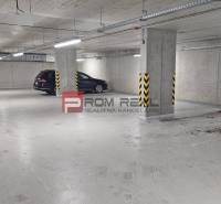 Underground garage with a concrete floor and a parked car.