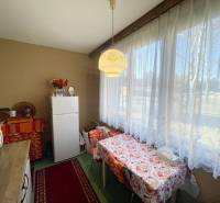 Kitchen in a 3-room apartment with a dining table and a large window.