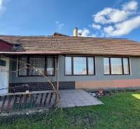 A family house in Mýtne Ludany with a yard, terrace, and gray facade.